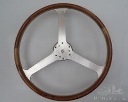 Three spoke wood rimmed wheel