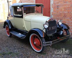 A really attractive Model A Sport Coupe with dickey seat which goes every bit as well as it looks!