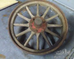 Wooden wheel 1910-1920 including spindle and hub cap