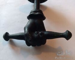 Antique clenched fist mascotte metal black