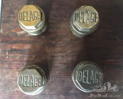 Four veteran Delage hubcaps