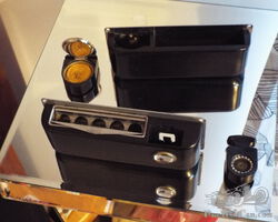 A RARE SET OF SMITHS MANS CIGARETTE LIGHTER AND ASH TRAY AND LADIES MATCHING POWDER PUFF AND MIRROR
