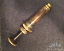 A small, brass air pressure/primer hand pump great. Great for early cars or speedsters.