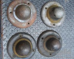 A set of four 1914-1918'ish REO wheel center hub covers /hubcaps