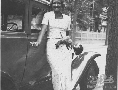 Stunning lady outdoing mystery car...