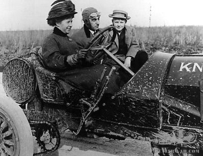 American female racing driver Joan Cuneo in a muddy chain-driven Knox
