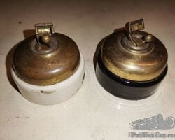 Two Lundberg electric switches, black and white