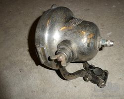 C.A.V. electric motorcycle headlamp with bracket.