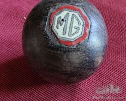 A rare early hardwood gearknob with enamel MG badge inlayed.